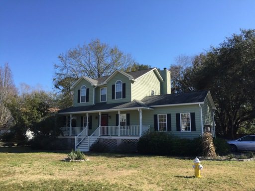 A large two story house yellow coloured house at 2235 Backwater Ct Charleston, SC 29412