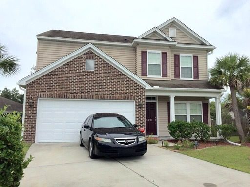 A story house with a black car in front of it at 5007 Brownhare Court Summerville, SC 29485