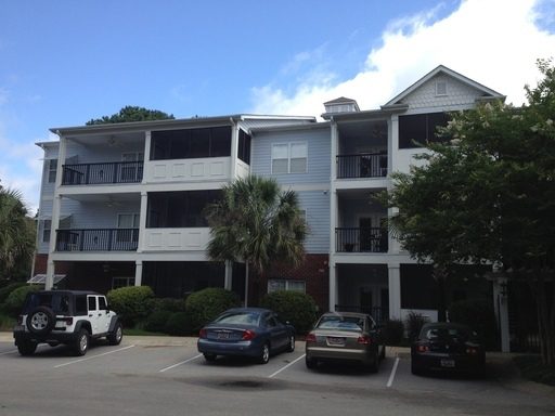 A two story house with cars in front of the house at 1025 Riverland Woods Place #608 Charleston, SC 29412