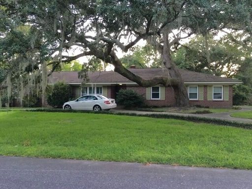 A single story house with white car in front of it at 411 Owen Street Charleston, SC 29414