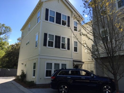 A three story light yellow coloured house with car parked outside at 63 Warrick Oaks Lane Mount Pleasant, SC 29464