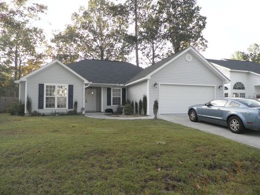 A single story white coloured house with large lawn at 743 Bunkhouse Drive Charleston, SC 29414