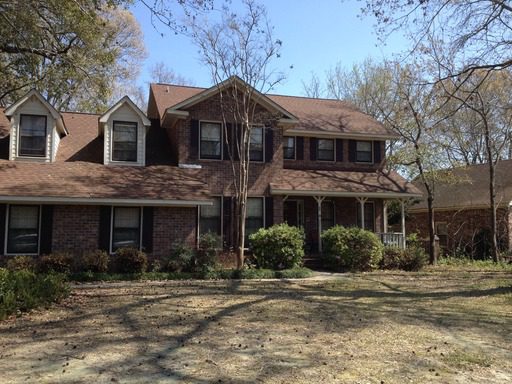 A two story red coloured house at 33 Brisbane Drive Charleston, SC 29407
