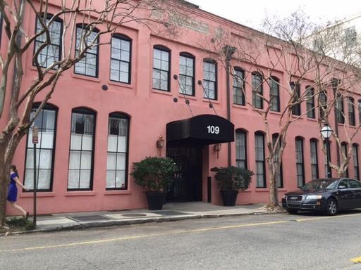 A large red coloured condo building at 109 East Bay Street #1G Charleston, SC 29401