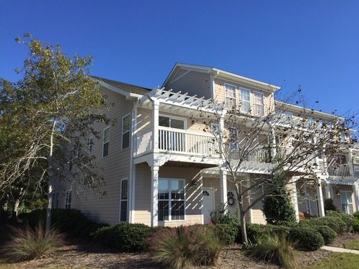 A two story house with lots of plants and bushes outside at 3036 Sugarberry Lane Johns Island, SC 29455