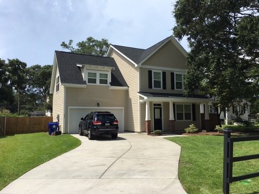 An image of two story yellow coloured house with black car outside it at 949 Dills Bluff Road Charleston, SC 29412