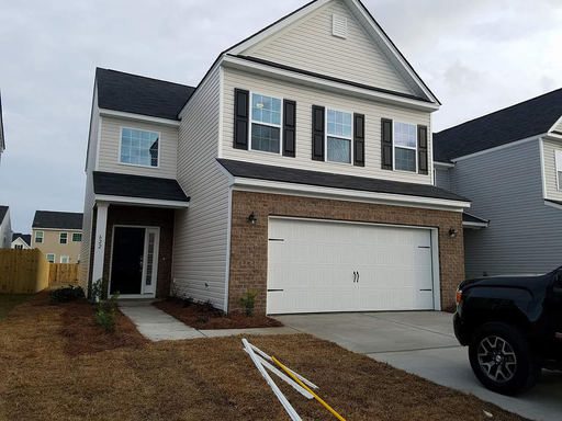 A two story house cream coloured house at Redbud Lane Summerville, SC 29483