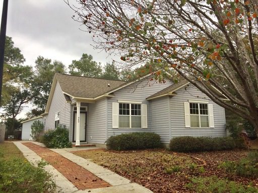 A single story white coloured house and large frontyard at Provincial Circle Mount Pleasant, SC 29464