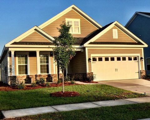 A two story brown colour house with garden in front at Goodlet Circle Charleston, SC 29412