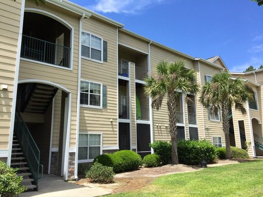 A two story cream coloured condo and lawn upfront at Park West Blvd #1015 Mount Pleasant, SC 29466