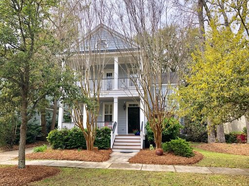 A two story grey coloured house and lawn upfront of the house at Etiwan Park Street Daniel Island, SC 29492