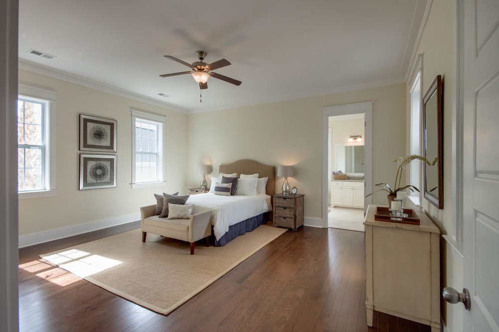 An inside image of the large bedroom with white bed