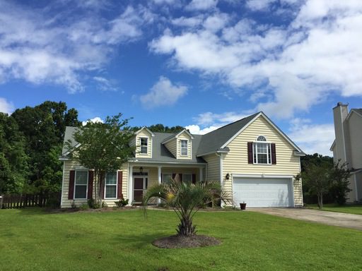 A yellow coloured two story house with large lawn in front of it at Spring Meadows Road Summerville, SC 29485