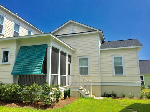 An image of a beautiful yellow coloured house with lawn upfront