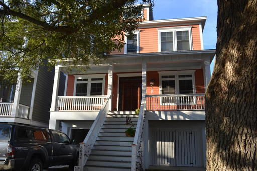 A two story red house with staircase coming down from the main entrance at S. Shore Drive Charleston, SC 29407