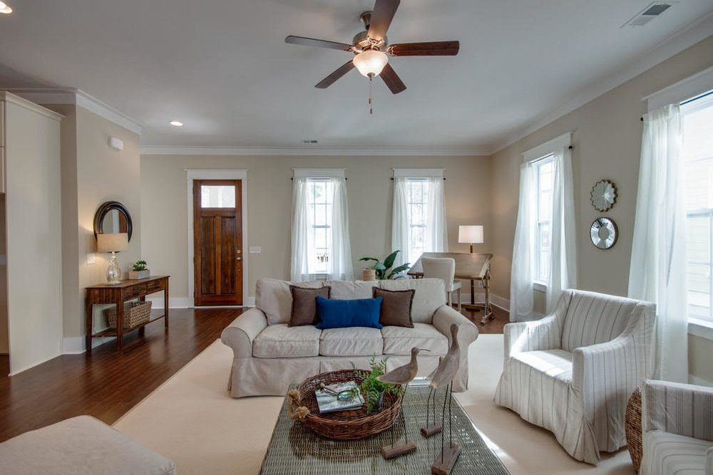 An inside image of white coloured living room with sofas at Carolina Park in Mount Pleasant.