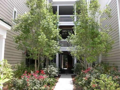 A three story house with lots of bushes in front at 2521 Egret Crest Lane Charleston, SC 29414