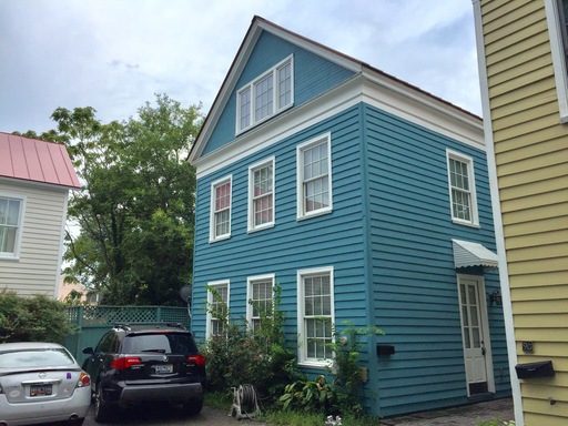 A two story blue colour house with two cars in front at 9F Bogard Street Charleston, SC 29403