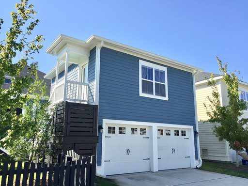 An image of two story house with two white coloured parking lots at Daniel Island