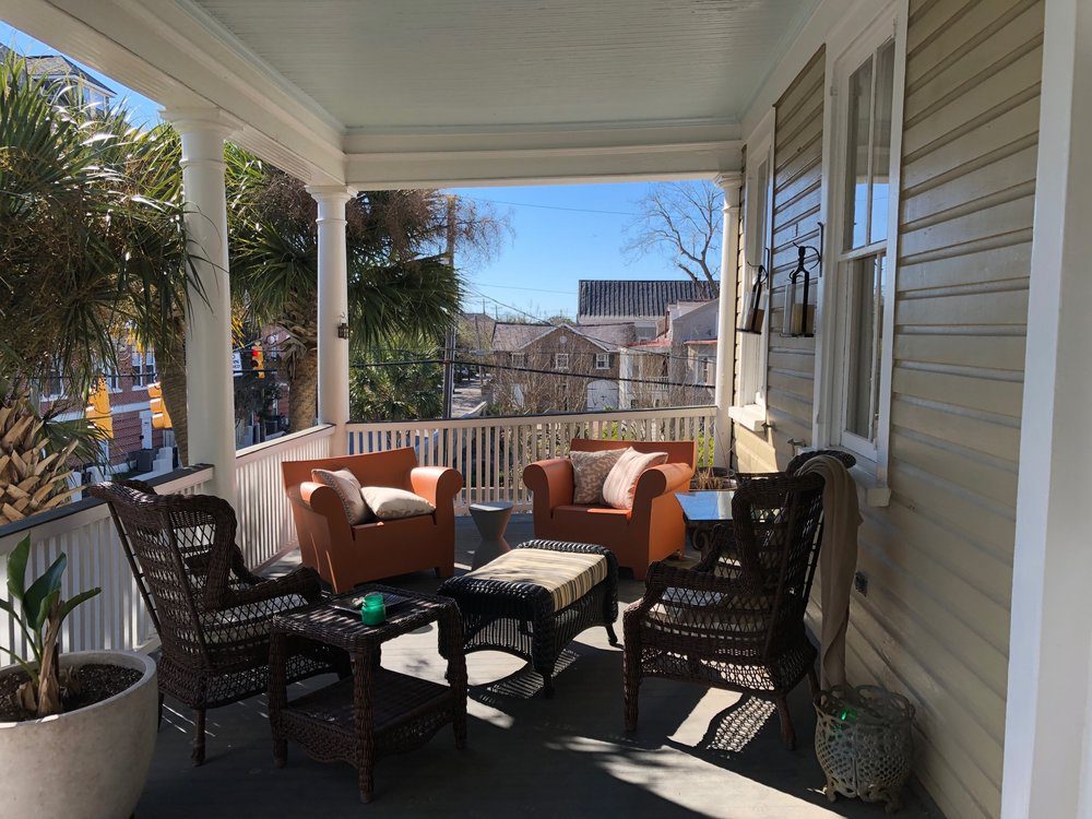 Couches and chair in the balcony of Harleston Village Apartment