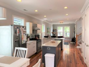 An image of the white coloured dining table and kitchen