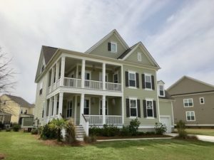 A two story green coloured house with garden upfront at Whisker Pole Lane Mount Pleasant, SC 29466
