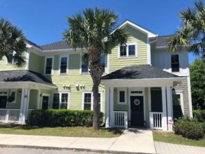 A two story green coloured house with two large trees at Blakeway Street Unit 602 Daniel Island, SC 29492