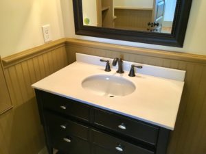 An inside image of restroom with white top basin