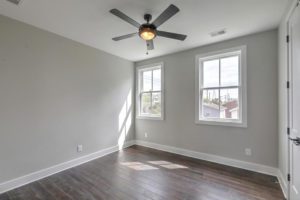 An unfurnished bedroom with fan rotating inside it