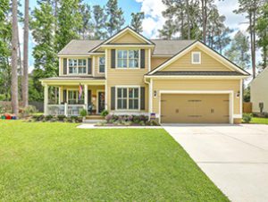 A two story yellow coloured house at President Circle Summerville, SC 29483 with large lawn in front of it