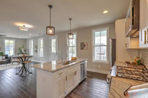 An inside image of the kitchen with counter and three round chairs