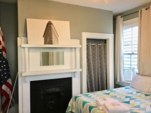Double beds in the bedroom with fireplace adjacent to it