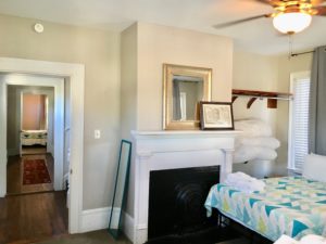 Double beds in the bedroom with fireplace adjacent to it