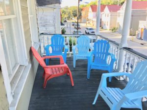 An image of lot of chairs in the balcony