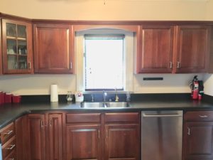 An image of the kitchen with brown cabinets