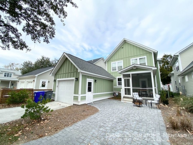 Backyard of a two story green colour house