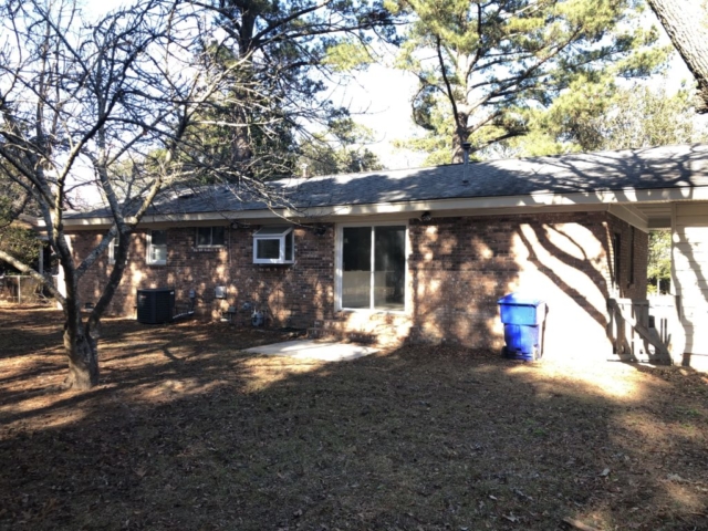 A one story house with yard next to it at 1832 Gippy Lane West Ashley Plantation