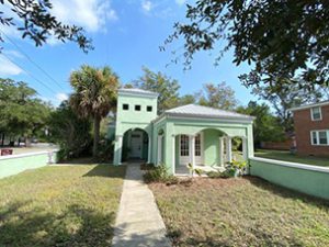 A single story light green coloured house with large frontyard at Rutledge Avenue Charleston, SC 29403