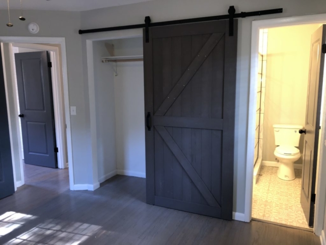 An inside image of the house showing empty room and a bathroom attached to it