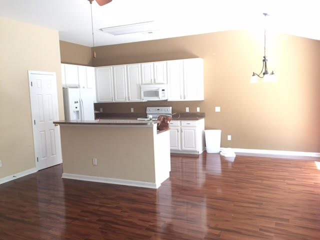 An unfurnished kitchen and living room