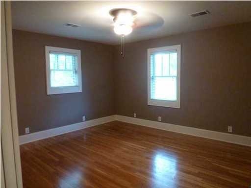 An empty room with wooden floor