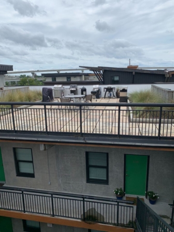 An image of the sitting area with outdoor grill on the terrace